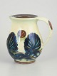 Kähler, jug with relief decoration.Jug in glazed stoneware with pronounced relief decoration ...