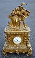 French mantel clock in gilt bronze, 1810 - 1820. Charles X. The clock is decorated with figures ...