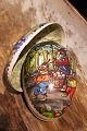 Old vintage Easter egg in papier-mâché with a motif of Easter bunnies collecting Easter eggs. ...