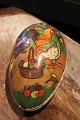 Old vintage Easter egg in papier-mâché with a motif of an Easter bunny and chickens collecting ...