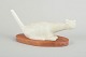 Lillemor Petersson for Rörstrand, cat figure on wooden stand.Naturalistically shaped cat in ...