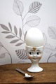 Old egg cup from the 1930s in porcelain with a painted funny face. Height: 6cm.