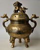 Chinese bronze incense burner on three legs, 19th century. With two handles; openwork lid with ...