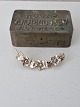 Vintage silver brooch shaped like a vine with flowers and leaves. Stamped 830s. Length 5.7 cm. ...