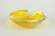 Murano, bowl.Organically shaped art glass bowl in yellow glass with clear rim and softly ...