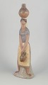 Lladró figurine, woman with vessels.Large porcelain figurine depicting a standing woman ...