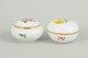 Meissen, set of two lidded jars with polychrome flower decoration.Set of two porcelain lidded ...