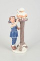 Royal Copenhagen figurine, girl by birdhouse. Year figurine 2001.Fine porcelain figurine ...