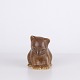 Bear figure by Knud Basse made in brown glazed ceramic. The figure shows a seated bear with ...