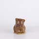 Bear figure by Knud Basse made in light brown glazed ceramic. The figure shows a seated bear ...