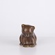 Bear figure by Knud Basse made in brown glazed ceramic. The figure is modeled in a seated form ...