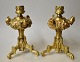 Pair of French bronze candlesticks, 19th century. With decorations in the form of faces. On ...