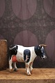 Decorative, old dairy cow in carved wood with fine original painting, horns and tail in leather. ...