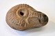 Antique Roman oil lamp. Ancient times. Red clay. With decorations on the top. L.: 8 cm.