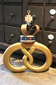 Old baker's sign shaped like a pretzel, gilded with a metal crown. Comes from a bakery and is ...