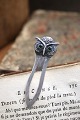 Old silver bookmark in the shape of a small owl with green glass eyes. Stamped 830s. Length: 5.8cm.