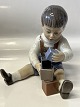 Dahl Jensen figurine, boy with blocks.The factory mark shows that this was produced between ...