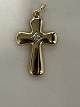 Gold Cross with a zircon. in 14 caratsStamped: JAa 585.Height with eyelet: 2.6 cm.Width: ...