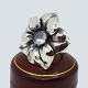 Regitze Overgaard for Georg Jensen; Flower ring in silver, set with a moonstone, no. 562a. Ring ...