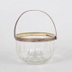 Glass sugar bowl with silver-plated handle.