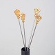 Skultuna, set of four cocktail sticks with crown motif.