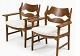 A pair of Razorblade armchairs by Henning Kjaernulf covered with new lambskin. Fantastic ...