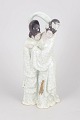 Chinese porcelain sculpture.Decorative porcelain figure group with crackle glaze, depicting ...