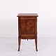 Bedside table crafted in dark wood with brass mounts and elegant tapered legs. Dating from the ...