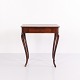 Mahogany side table with a drawer and elegantly curved legs. Dating from around 1910, the table ...