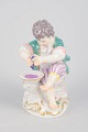 Meissen, boy with grape press figurine.Porcelain figurine depicting a boy squeezing grapes ...