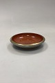Royal Copenhagen Crackle Bowl No. 212/2559. Siena red with gold. Measures 17.2 cm / 6.77 in.