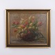 Oil painting on canvas depicting tulips arranged in a woven basket. The painting was created ...