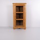 Antique corner cabinet crafted from pine with a glass door and three interior shelves. The ...