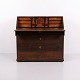 Antique Late Empire secretary desk crafted from oak with decorative inlay and brass fittings. ...