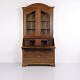Antique secretary desk crafted from oak with brass fittings and an upper glazed display cabinet. ...