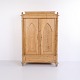 Antique wardrobe made of pine from the 20th century. The cabinet features decorative carved ...