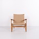 CH25 armchair designed by Hans J. Wegner, made of patinated solid oak with a woven seat and ...