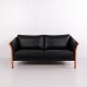 Classic two-seater sofa by Hjort Knudsen, made with a solid wood frame and black leather ...