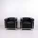 Pair of LC2 armchairs in black leather with exposed chromed steel frames. The model was designed ...