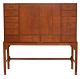 Chest of drawers designed by Knud Juul Hansen, Denmark, crafted in teak. The piece features a ...