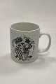 Faience monthly mug for February – MASKERADE. Designed by Bjørn Wiinblad for Nymølle. In ...