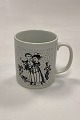 Faience monthly mug for November – OPTIMISME. Designed by Bjørn Wiinblad for Nymølle. Shows ...