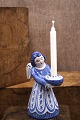 Large ceramic angel with blue glaze holding a small ...