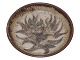 Royal Copenhagen art potteryLarge bowl featuring a stylized flower and sweeping leaves in relief, by Gerd Bøgelund.