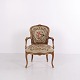 Antique Louis XV Revival armchair dating from circa 1880–1910, with a carved wooden frame, ...