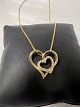 Venezia necklace with heart pendant and diamonds in 14 carat gold.The necklace is mounted with ...