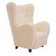 Upholstered high-back lounge chair appears with new sheepskin upholsteryDenmark ca. ...
