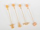 Andreas Mikkelsen for Georg Jensen, set of four Golden Christmas candleholders.Four brass ...