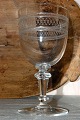 Wine glass with 
guilloche 
decoration on 
the bowl. 
Height 18.6 cm. 
Diameter 9.7 
cm. Fine ...