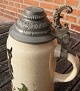 Large pitcher in faience with tin lid, decorated with a pixie